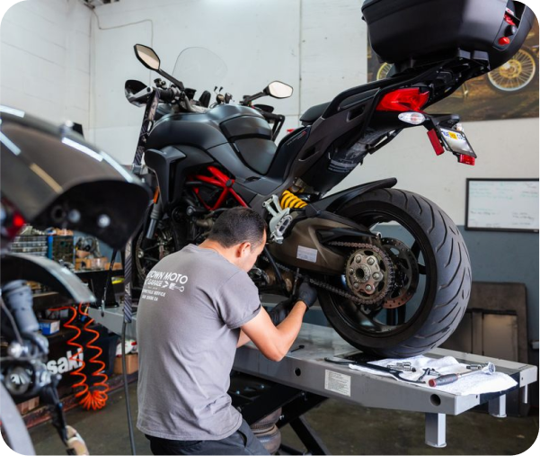 Motorcycle being repaired by mechanic.